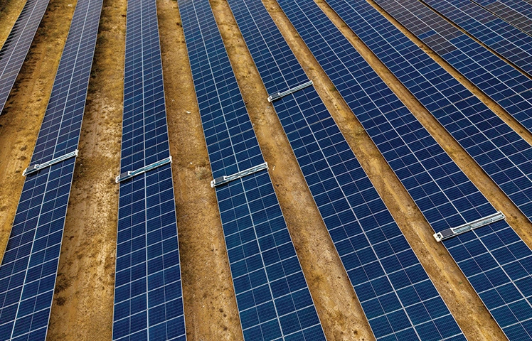 Aerial of solar panels over arid land