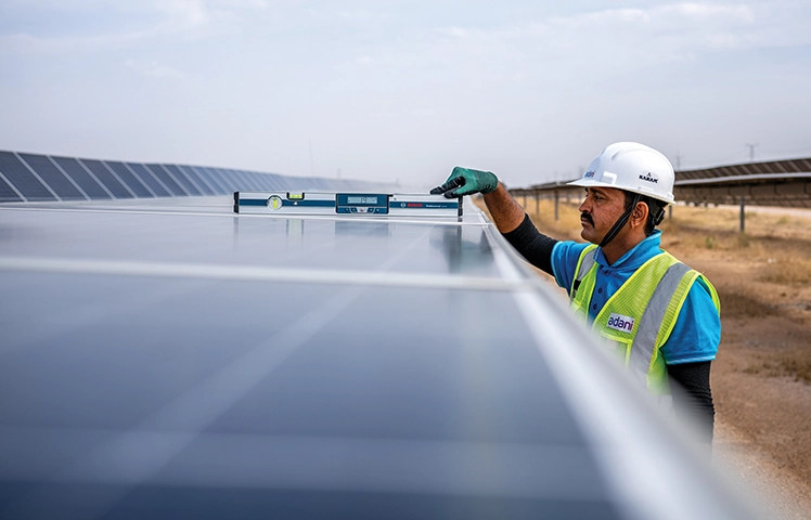 Badi Sid, Rajasthan - technician inspecting solar module