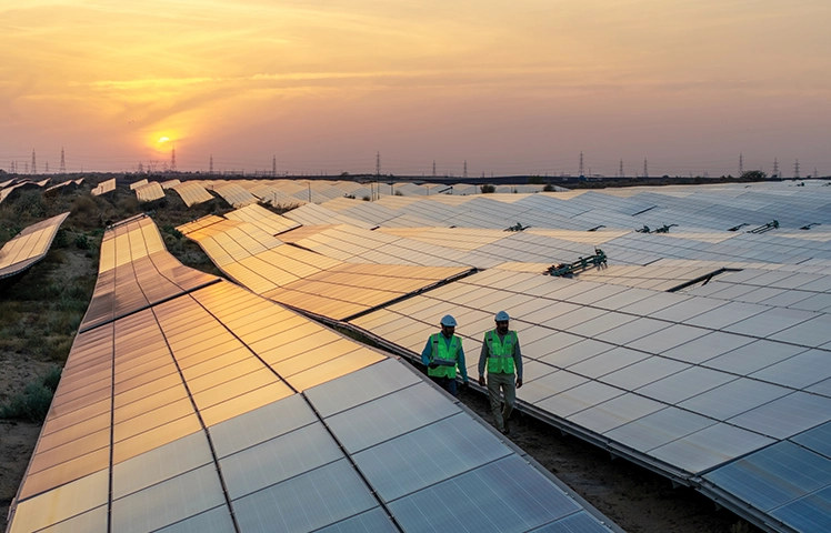 Bhadla, Rajasthan - workers on solar farm at sunset