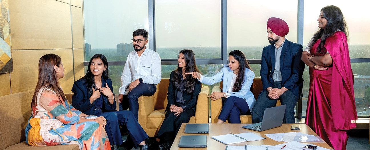 Diverse AGEL team in discussion (boardroom lounge)